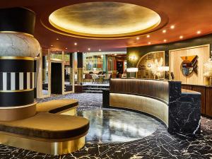 a lobby of a hotel with a circular ceiling at Nest Hotel Paris la Défense - MGallery Collection in Puteaux