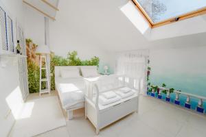 a white room with a bed and a window at Divas Upes SPA hotel Koknese in Koknese