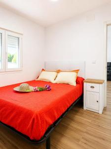 a bedroom with a red bed with flowers on it at Casa Aljubet in Onil