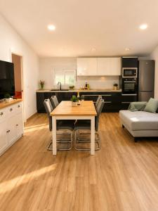 a kitchen and living room with a table and a couch at Casa Aljubet in Onil