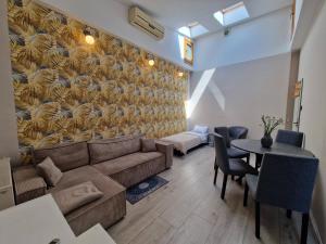 a living room with a couch and a table at Promień 4 by Zen4Guest - Biskupin in Wrocław