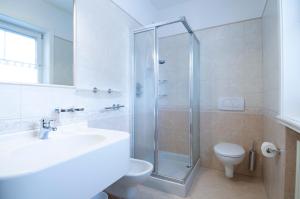 a bathroom with a shower and a sink and a toilet at Chalet Betty in Livigno +20 photos