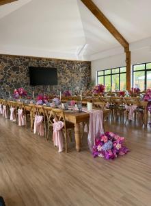 a banquet hall with tables and chairs and flowers at Pensiunea Maramures Guesthouse in Vişeu de Jos +101 photos