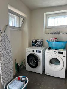 a laundry room with a washing machine and a washer at Lake House Lesa - Lakeside Villa Lago Maggiore in Lesa