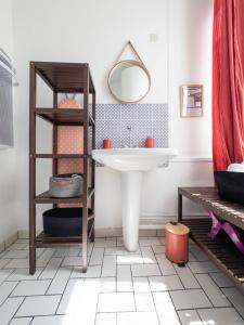 a bathroom with a sink and a shelf at Les Fontaines in Bernay +20 photos