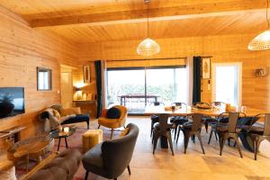 a living room with a table and chairs at chalet 1 - les jolis chalets in Barbey-Séroux