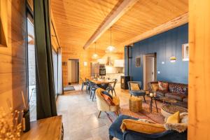 a living room with a couch and a table at chalet 1 - les jolis chalets in Barbey-Séroux