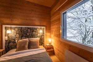a bedroom with a bed and a window at chalet 1 - les jolis chalets in Barbey-Séroux +55 photos