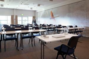 a room with tables and chairs and a large wall at Scandic Hvidovre in Hvidovre +39 photos