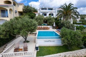 an image of a villa with a swimming pool at LUXURY VILLA CIOVO Sleeps 17, Infinity Pool, Seafront in Trogir