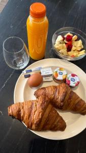 a plate of food with an egg and a croissant at Guesthouse Ouddorp Connection in Ouddorp +6 photos