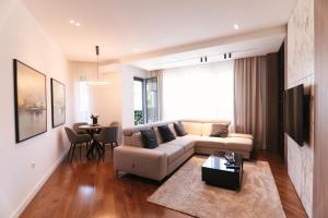 a living room with a couch and a table at ModernApartmentsBL in Banja Luka