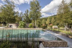 a swimming pool in a yard with a fence at chalets 4 - les jolis chalets in Barbey-Séroux