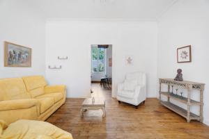 a living room with a couch and a table at Maison le 28 in Jugon Les Lacs