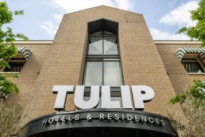 a sign on the side of a building at TULIP Hotels & Residences - Zwolle in Zwolle