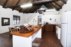 a kitchen with a wooden counter top and a refrigerator at The Barn Main House in Arniston