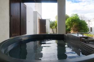 a swimming pool in the backyard of a house at The Barn Main House in Arniston