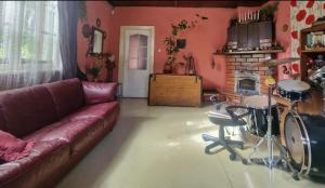 a living room with a couch and a table with drums at Bungu Bangu in Ventspils