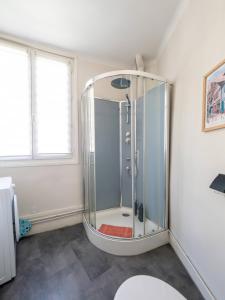 a bathroom with a shower with a glass enclosure at La Chaussee in Bernay