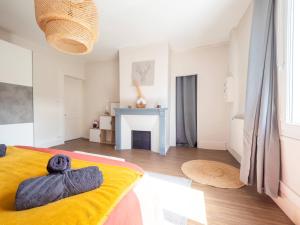 a bedroom with a bed with a yellow blanket at La Chaussee in Bernay