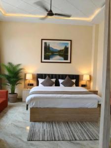 a bedroom with a large bed and a couch at Shree Videhi Atithi Grah in Ayodhya