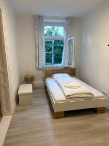 a bedroom with a bed and a window at Modern Apartment Melk - Altstadt & Parkplatz in Melk +9 photos