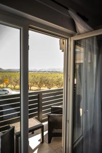 a balcony with sliding glass doors with a view of a field at Pansioni Centar in Mostar