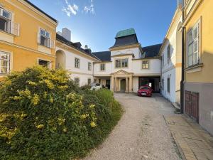 a house with a red car parked in the driveway at Modern Apartment Melk - Altstadt & Parkplatz in Melk