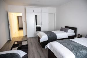 a hotel room with two beds and a hallway at Pansioni Centar in Mostar +46 photos