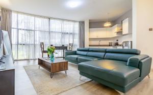a living room with a couch and a table at Kika Des Hotel Suites - Serviced Apartments, Westland, Nairobi in Nairobi