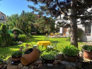 a garden with a table and some potted plants at Hotel Garni Expo in Banská Bystrica