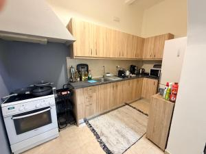 a kitchen with wooden cabinets and a white stove top oven at GIANNIS HOUSE in Rhodes Town