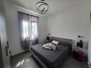 a bedroom with a large bed and a window at Fiumicino Beach - Sleep & Fly in Focene