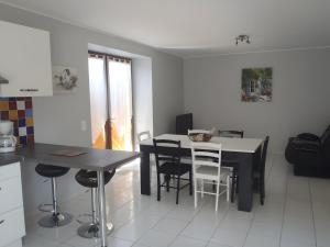 a kitchen and dining room with a table and chairs at Gite Chez Santou in Rocamadour