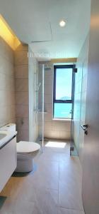 a bathroom with a toilet and a shower and a window at 4BR Beachfront Pantai Cenang Langkawi in Pantai Cenang +37 photos