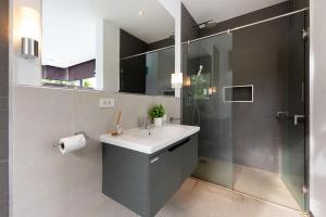 a bathroom with a sink and a shower at 4BR Luxury Pool Retreat - Villa Azura Nai Harn in Nai Harn Beach