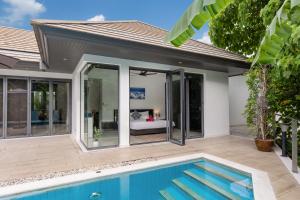 a house with a swimming pool in front of it at 4BR Luxury Pool Retreat - Villa Azura Nai Harn in Nai Harn Beach