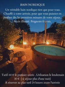 a poster of a hot tub in a yard at night at Domaine de la Mance - Maisonnette avec cheminée, bain nordique en supplément in Vitrey
