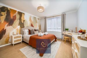 a bedroom with a bed and a desk and a window at Chalfont Haven in Latimer