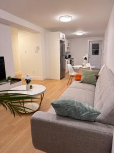 a living room with a couch and a table at Modern 2BR Suite, Wifi, Workstation and Comfy Beds in St. John's