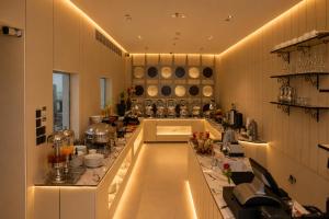 a large kitchen with a long counter in a room at La Terrasse Hotel in Jeddah