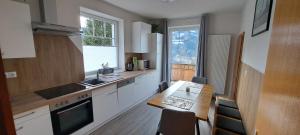 a kitchen with a table and a sink and a stove at Haus Weisl in Erlsberg