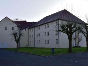 a large white building with trees in front of it at Hôtel Ibis Nevers in Nevers