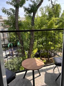 a table and chairs on a balcony with a view at Modern Apt in Shymkent