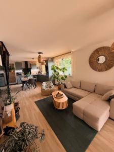 a living room with a couch and a table at Le 25 Bis Spa&Sauna aux portes de Montauban in Lamothe-Capdeville