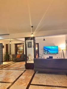 a living room with a couch and a flat screen tv at White City Pension in Antalya