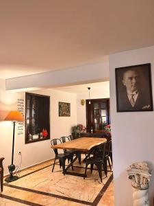 a dining room with a wooden table and chairs at White City Pension in Antalya