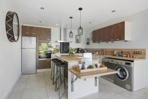 a kitchen with a sink and a dishwasher at Gite Du Bois in Ponts +18 photos