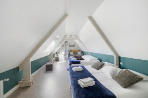 a attic room with four beds in it at Gite Du Bois in Ponts