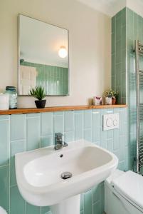 a bathroom with a sink and a mirror at Dalforth Thaxted Barn Collection in London Stansted Airport +70 photos